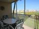 Enjoy relaxing views from this screened balcony, featuring a table and chairs at 2180 Heron Lake Dr # K-208, Punta Gorda, FL 33983