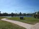 Well-maintained tennis courts with paved pathway at 2180 Heron Lake Dr # K-208, Punta Gorda, FL 33983