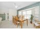 Bright dining room with wood table and chairs, leafy wallpaper, and large window at 2218 Cassino Ct, Punta Gorda, FL 33950