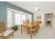 Dining room with wood table and chairs, leafy wallpaper, and large window at 2218 Cassino Ct, Punta Gorda, FL 33950