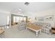 Bright living room with plaid sofas, coffee table, and view into dining area at 2218 Cassino Ct, Punta Gorda, FL 33950