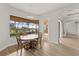 Breakfast nook with a round table and chairs, overlooking the pool at 2408 Silver Palm Rd, North Port, FL 34288