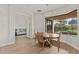 Bright dining area with wood table and chairs, offering views of the backyard at 2408 Silver Palm Rd, North Port, FL 34288