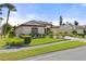 Single-story home with a 2-car garage and manicured lawn at 2408 Silver Palm Rd, North Port, FL 34288