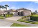 Single-story home with a tile roof, three-car garage, and landscaped yard at 2408 Silver Palm Rd, North Port, FL 34288