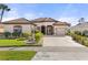 One-story house featuring a tile roof, three-car garage, and neatly landscaped front yard at 2408 Silver Palm Rd, North Port, FL 34288