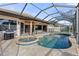 Inviting pool and spa with a covered patio and outdoor kitchen at 2408 Silver Palm Rd, North Port, FL 34288