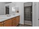 Double vanity bathroom with light wood cabinets and a large shower at 24356 Westgate Blvd, Punta Gorda, FL 33980