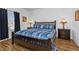 Spacious bedroom with a king-size bed and dark wood furniture at 24356 Westgate Blvd, Punta Gorda, FL 33980