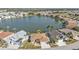 Aerial view of house and community near lake at 24424 Buckingham Way, Punta Gorda, FL 33980