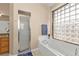 Bathroom with shower, bathtub, and large window at 24424 Buckingham Way, Punta Gorda, FL 33980