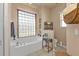 Bathroom with soaking tub and glass block window at 24424 Buckingham Way, Punta Gorda, FL 33980