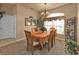 Bright dining room with wood table and chairs, near entryway at 24424 Buckingham Way, Punta Gorda, FL 33980