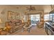 Living room with lake views and access to lanai at 24424 Buckingham Way, Punta Gorda, FL 33980