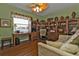 Home office with built-in shelves and hardwood floors at 24424 Buckingham Way, Punta Gorda, FL 33980