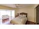 Bright bedroom with hardwood floors, a queen-size bed, and access to a sunroom at 25188 Marion Ave # 34, Punta Gorda, FL 33950