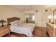 Well-lit bedroom featuring hardwood floors and mirrored closet doors at 25188 Marion Ave # 34, Punta Gorda, FL 33950