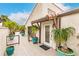 Deck with potted plants, leading to the entrance of the home with a white door at 25188 Marion Ave # 34, Punta Gorda, FL 33950