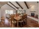 Bright dining area with hardwood floors, exposed beams, and a fireplace at 25188 Marion Ave # 34, Punta Gorda, FL 33950