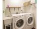 Convenient laundry room with washer, dryer, and utility sink at 25188 Marion Ave # 34, Punta Gorda, FL 33950