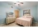 Light and airy bedroom with a queen bed, dresser, and ceiling fan at 2544 Warne St, Port Charlotte, FL 33952