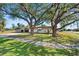 House exterior showcasing landscaping and large trees at 2544 Warne St, Port Charlotte, FL 33952