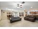 Bright living area with leather sofas, ceiling fan, and access to backyard at 2544 Warne St, Port Charlotte, FL 33952