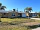 Single story home with a garage and palm trees in front at 2727 Poinciana Ct, Punta Gorda, FL 33950