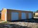 Triple-wide garage with three roll-up doors and one side door at 2727 Poinciana Ct, Punta Gorda, FL 33950