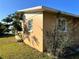 Tan house exterior with small trees and shrubs at 2727 Poinciana Ct, Punta Gorda, FL 33950