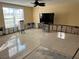 Living room with new tile floor and wall damage at 2727 Poinciana Ct, Punta Gorda, FL 33950