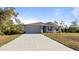 Single-story house with gray siding, a two-car garage, and a landscaped lawn at 2784 Dode Ave, North Port, FL 34288