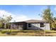 Single-story house with screened patio and grassy backyard at 2784 Dode Ave, North Port, FL 34288