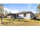 House exterior showcasing a screened porch and yard at 2784 Dode Ave, North Port, FL 34288