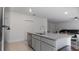 Kitchen island with granite countertop, sink, and gray cabinets at 2784 Dode Ave, North Port, FL 34288