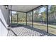 Relaxing screened porch with patterned flooring at 2784 Dode Ave, North Port, FL 34288