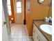 Bathroom with orange walls, tiled floor and a vanity at 2812 Cabaret St, Port Charlotte, FL 33948