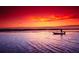 Person fishing at sunset on calm water at 2812 Cabaret St, Port Charlotte, FL 33948