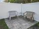 Small paved patio with two plastic benches and a small table at 2970 Cascabel Ter, North Port, FL 34286