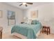 Bedroom with queen bed and teal bedding, and a side table at 2970 Cascabel Ter, North Port, FL 34286