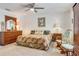 King-size bedroom with floral bedding, and wooden dresser at 2970 Cascabel Ter, North Port, FL 34286