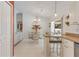 Bright dining area with glass table and chairs, near kitchen at 2970 Cascabel Ter, North Port, FL 34286