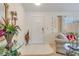 Bright and airy entryway with glass-top console table and seating area at 2970 Cascabel Ter, North Port, FL 34286