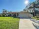 One-story home featuring a large yard and attached garage at 2970 Cascabel Ter, North Port, FL 34286