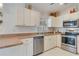 Modern kitchen with stainless steel appliances and light-colored cabinetry at 2970 Cascabel Ter, North Port, FL 34286