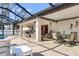 Covered patio overlooks the inviting pool, offering shade and relaxation at 2970 Cascabel Ter, North Port, FL 34286