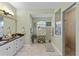 Elegant bathroom with a large shower, double vanity, and modern fixtures at 3008 Yeadon Ter, North Port, FL 34286