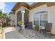 Relaxing front porch with seating area and lush plants at 3008 Yeadon Ter, North Port, FL 34286