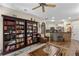 Bright living room with built-in bookshelves and a view into the kitchen at 3008 Yeadon Ter, North Port, FL 34286