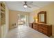 Bright bedroom with tiled floors, built-in shelving, and sliding glass door to patio at 311 Garvin St # 411B, Punta Gorda, FL 33950